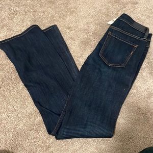 Express: dark blue denim. Boot cut Mid Rise jean. 6L